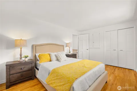 a bedroom with a bed and wooden floor