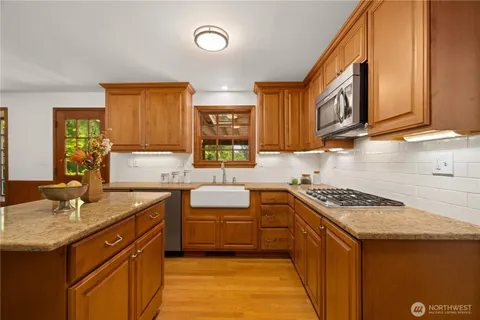 a kitchen that has a sink and a stove in it