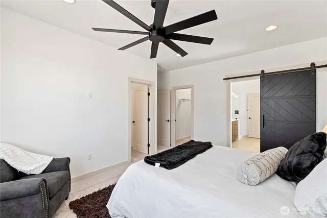 a bedroom with a bed and a couch