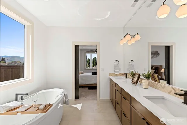 a spacious bathroom with a double vanity sink and a mirror