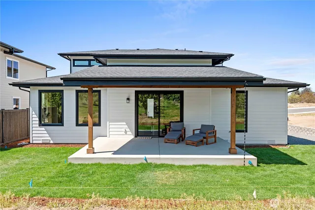 a view of an house with backyard porch and furniture