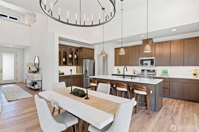 a large kitchen with a table and chairs