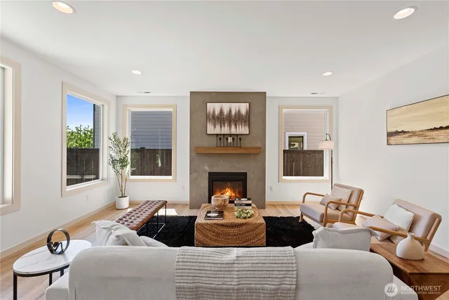 a living room with furniture fireplace and a window