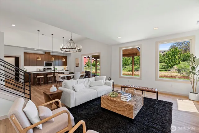 a living room with furniture fireplace and a large window