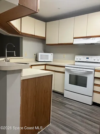 a kitchen with a sink and refrigerator