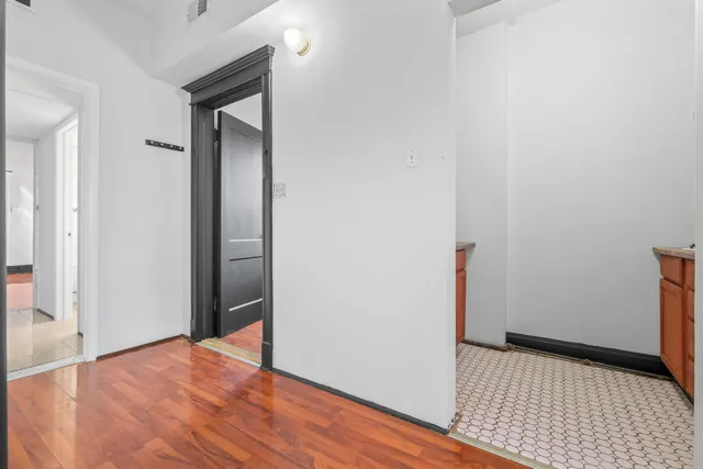 a view of a room with wooden floor