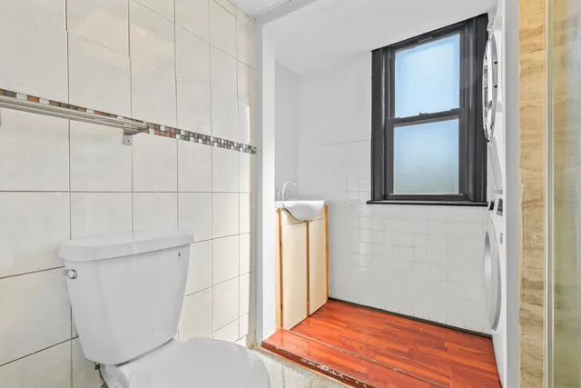a bathroom with a toilet and a shower