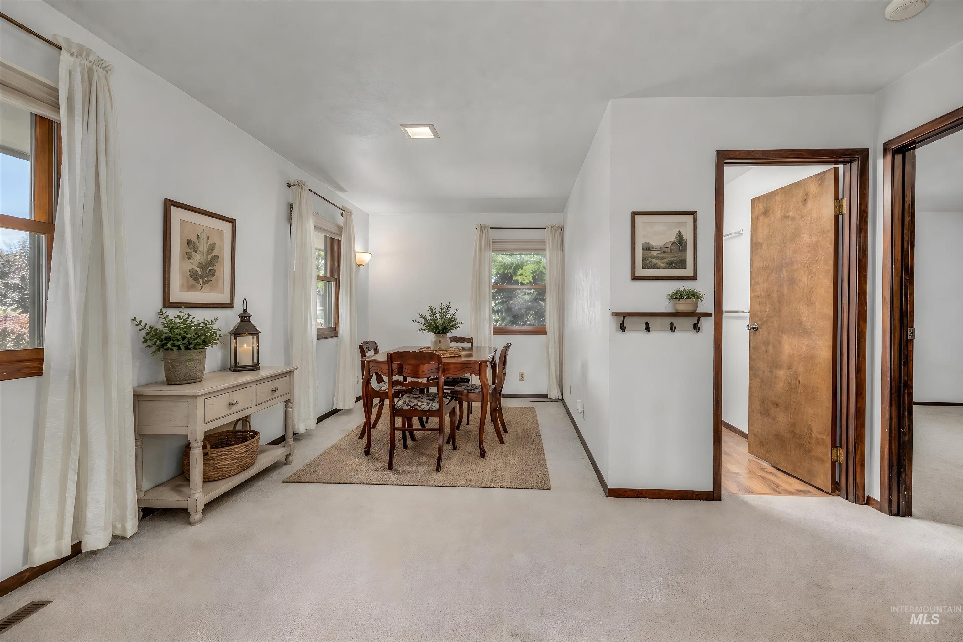 1493 Cove Road Weiser, ID 83672 - Photo 7 of 50 Neutral-toned carpeting extends throughout this interior space, complemented by white walls and wood-trimmed windows