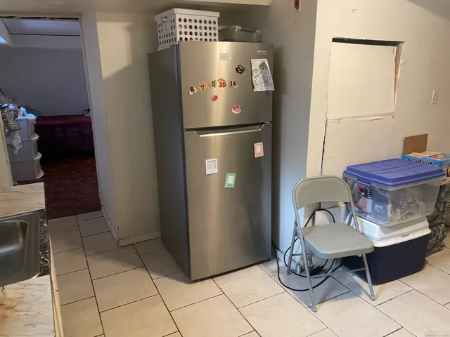 a kitchen with stainless steel appliances granite countertop a refrigerator and a stove