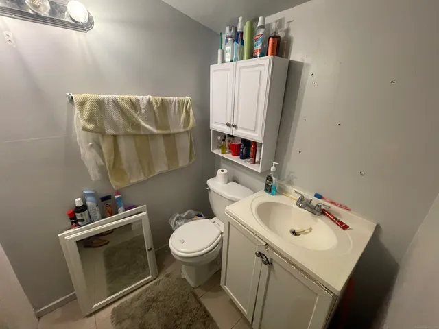 a bathroom with a sink toilet and a mirror