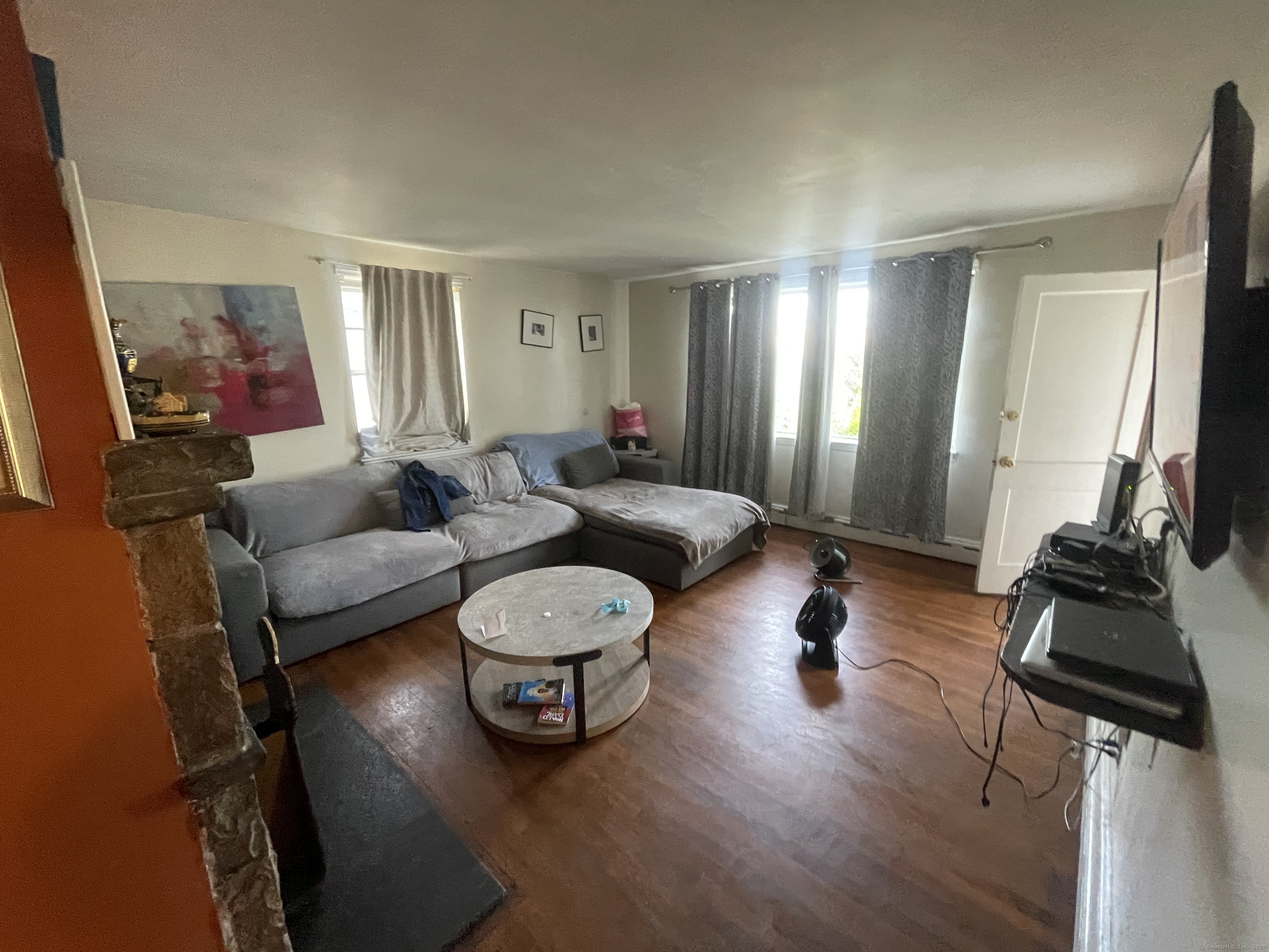 28 Anderson Street Stamford, CT 06902 - Photo 7 of 19 a living room with furniture and a flat screen tv
