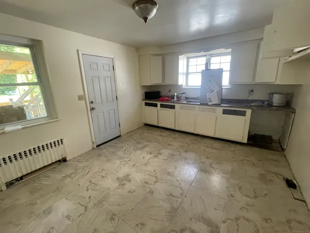 a kitchen with a refrigerator and window