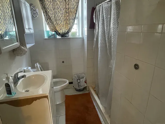 a bathroom with a sink a mirror and a toilet