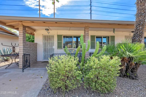 a view of a house with potted plants