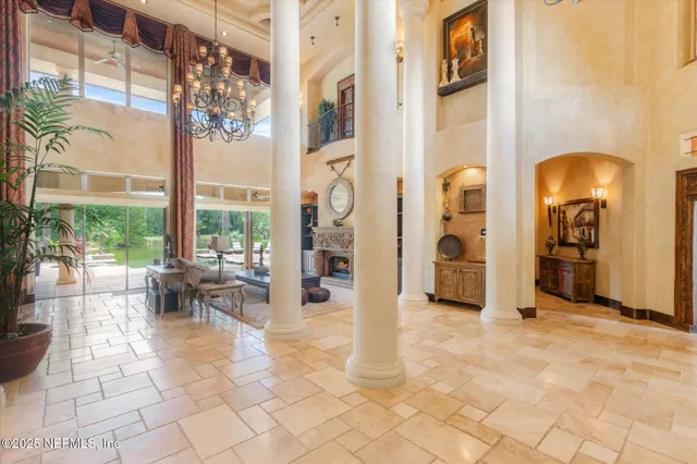 a view of a dining room with furniture and chandelier