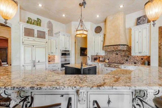 a bedroom with a bed a flat screen tv and a large window