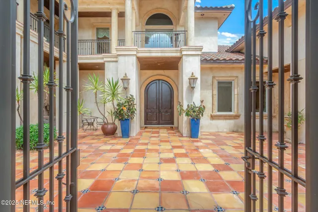 a view of a brick house with potted plants