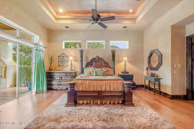 a view of a swimming pool with a lounge chair and palm trees