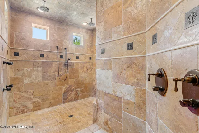 a front view of a house with a garden and plants