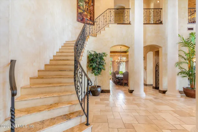 an aerial view of a house with garden space and a lake view