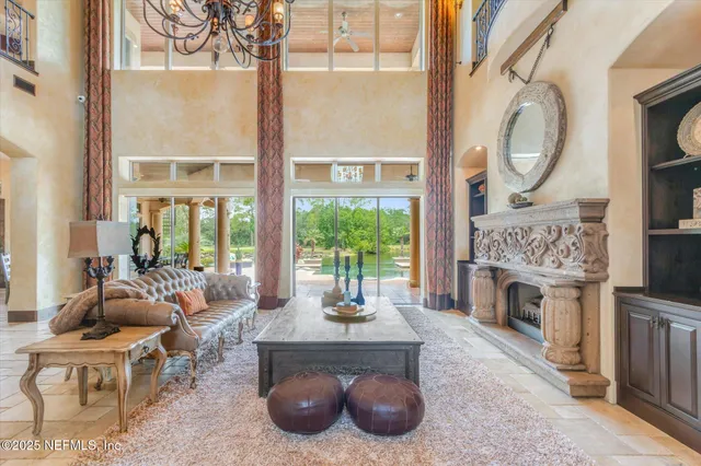 a kitchen with stainless steel appliances kitchen island granite countertop a table chairs stove and a kitchen island