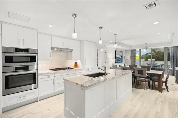 a kitchen with a stove a sink and a refrigerator