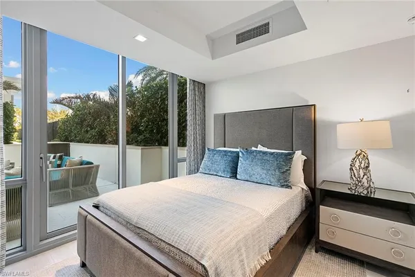 a bedroom with a large bed and a window