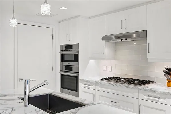 a kitchen with a stove and a refrigerator