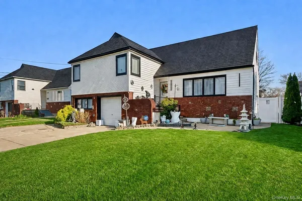 a view of a house with a yard and sitting area