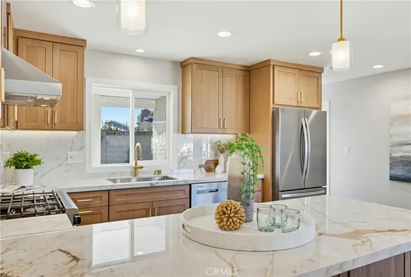 a bathroom with a granite countertop sink and a refrigerator
