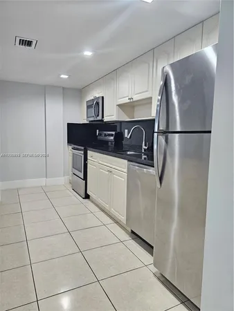 a view of kitchen and empty room