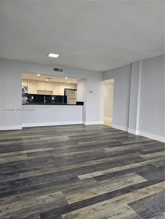 a large white kitchen with a sink and cabinets