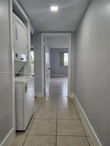 a view of a hallway with bathroom and sink