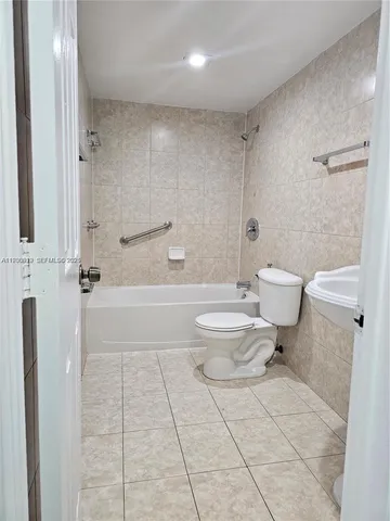a bathroom with a toilet a sink and shower