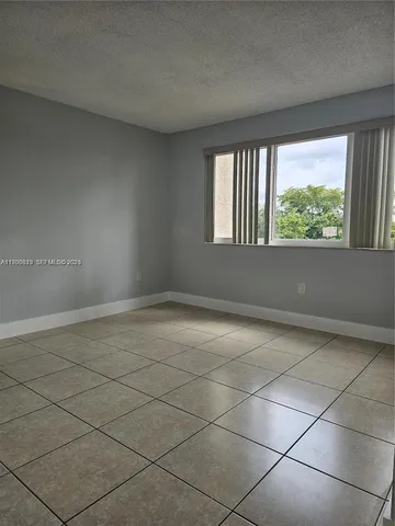 a view of a livingroom with an empty space and window