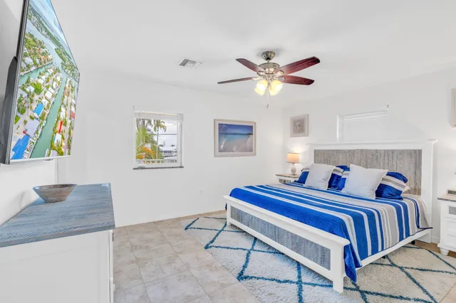 a bedroom with bed and a chandelier