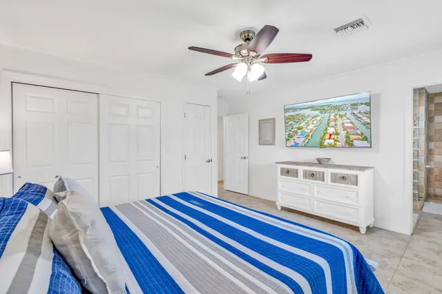 a bedroom with a bed and a chandelier