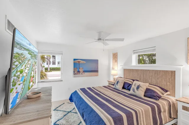 a bedroom with a bed and a painting on the wall