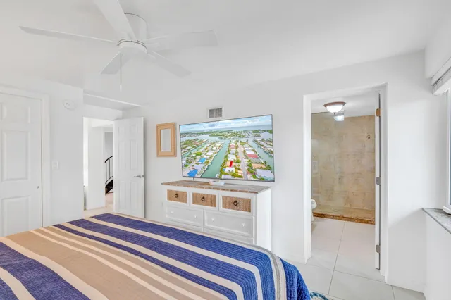 a bedroom with a bed and a painting on the wall