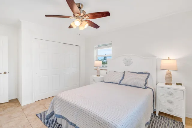 a bedroom with a bed and a lamp