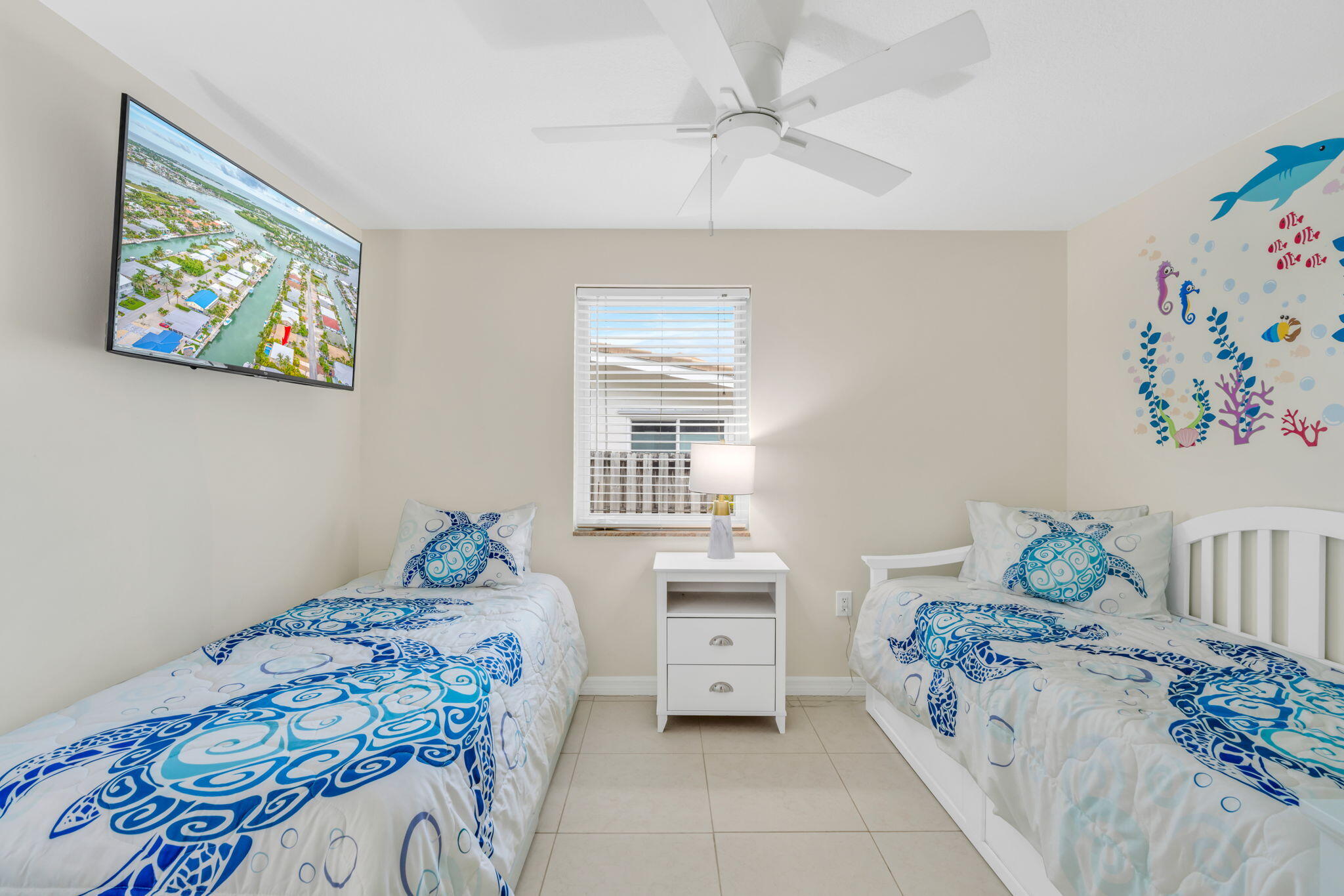 581 10th Street Key Colony Beach, FL 33051 - Photo 26 of 50 a bedroom with a bed and a window