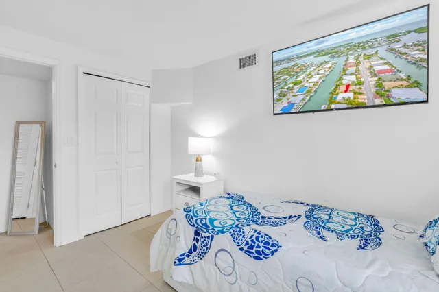 a bedroom with a bed and a painting on the wall