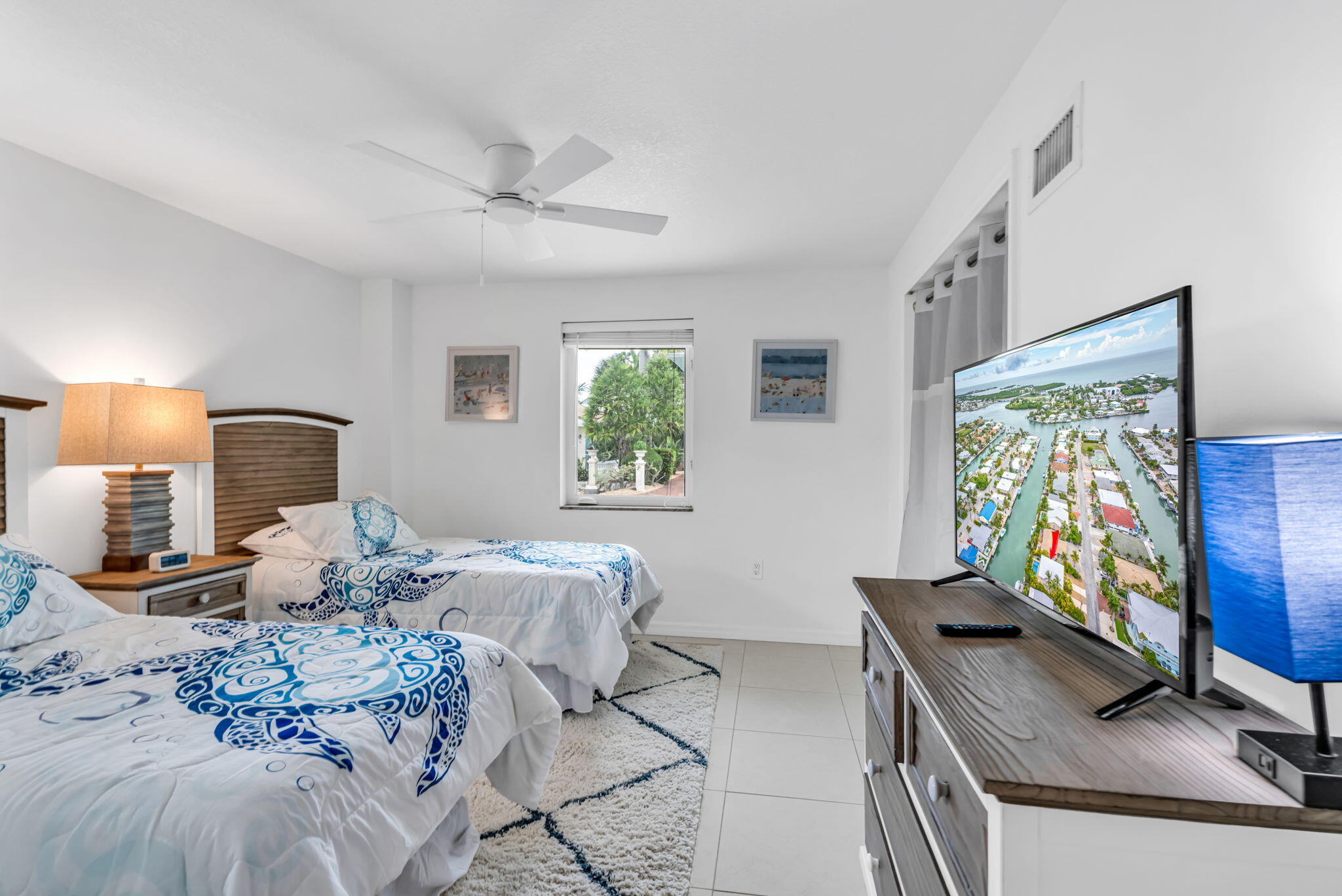 581 10th Street Key Colony Beach, FL 33051 - Photo 29 of 50 a bedroom with a bed window and a flat screen tv