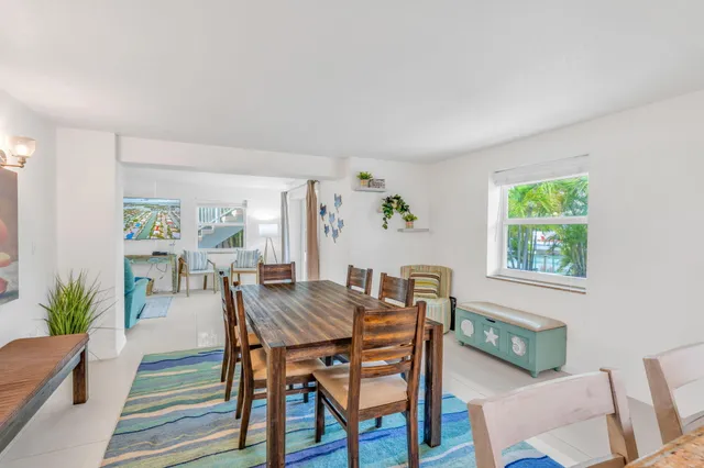 a view of a dining room with furniture and a potted plant