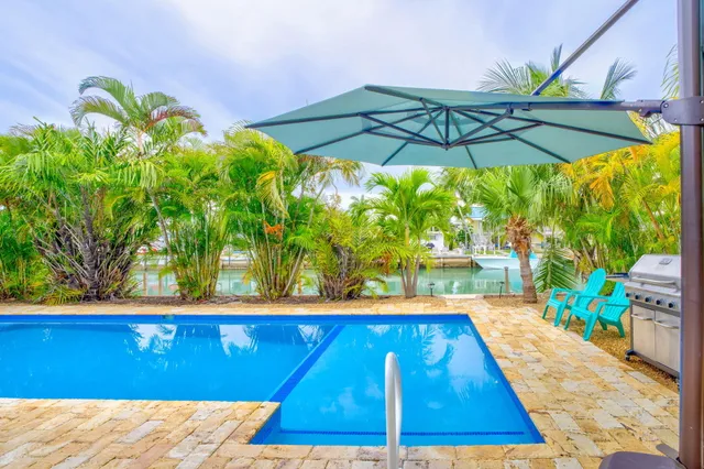 a view of swimming pool with a lounge chairs