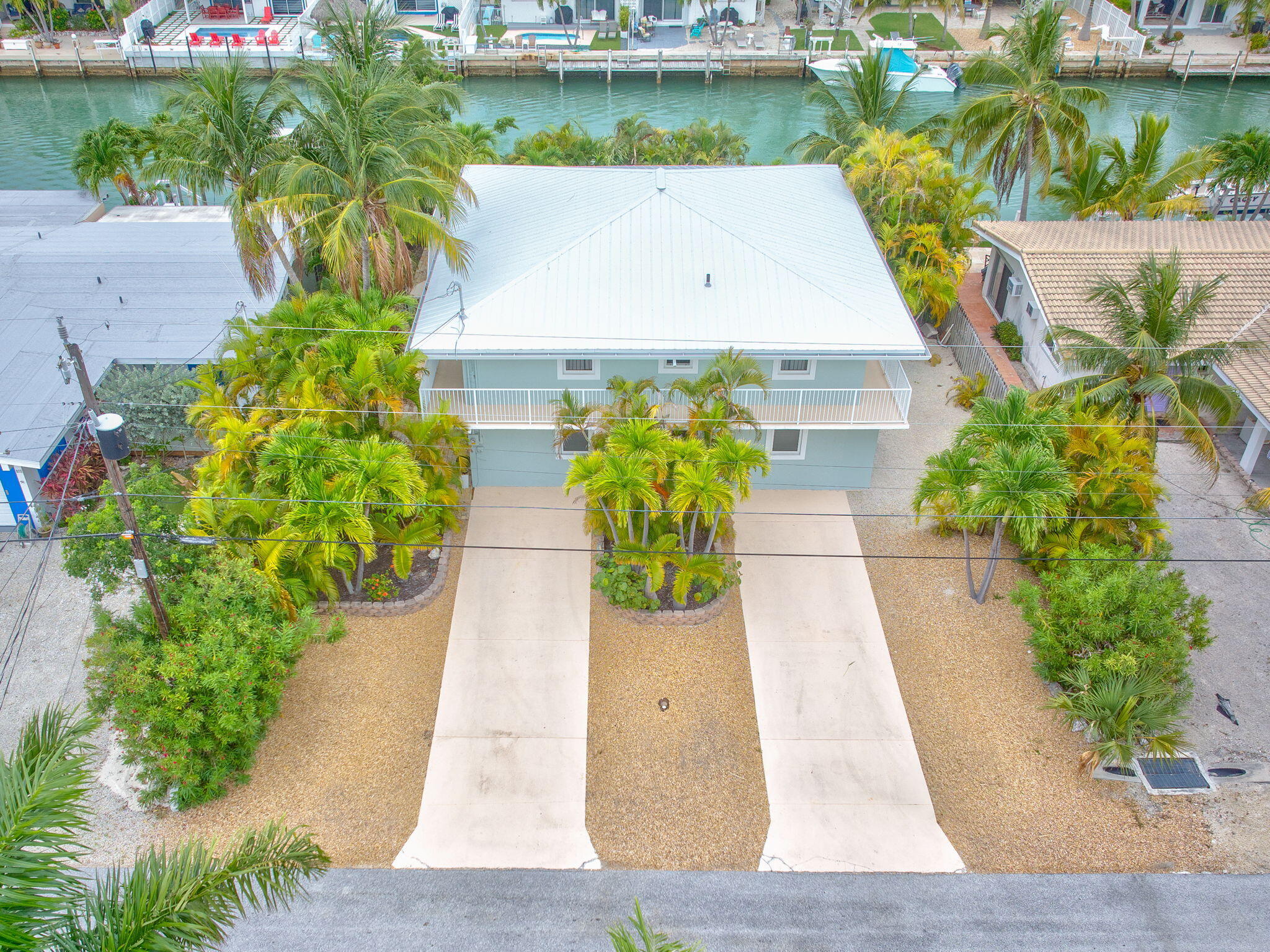 581 10th Street Key Colony Beach, FL 33051 - Photo 43 of 50 a view of a swimming pool with potted plants