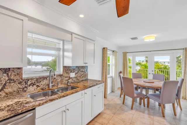 a kitchen with granite countertop a sink and a large window