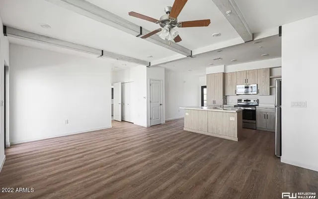 a view of kitchen with sink microwave and refrigerator