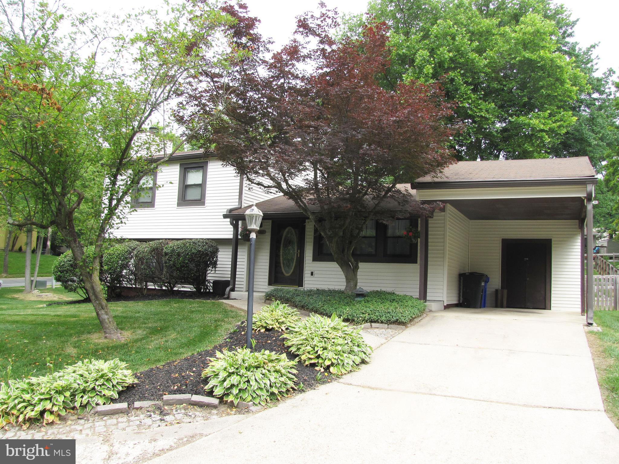 9600 Farewell Road Columbia, MD 21045 - Photo 1 of 18 a front view of a house with a yard and trees