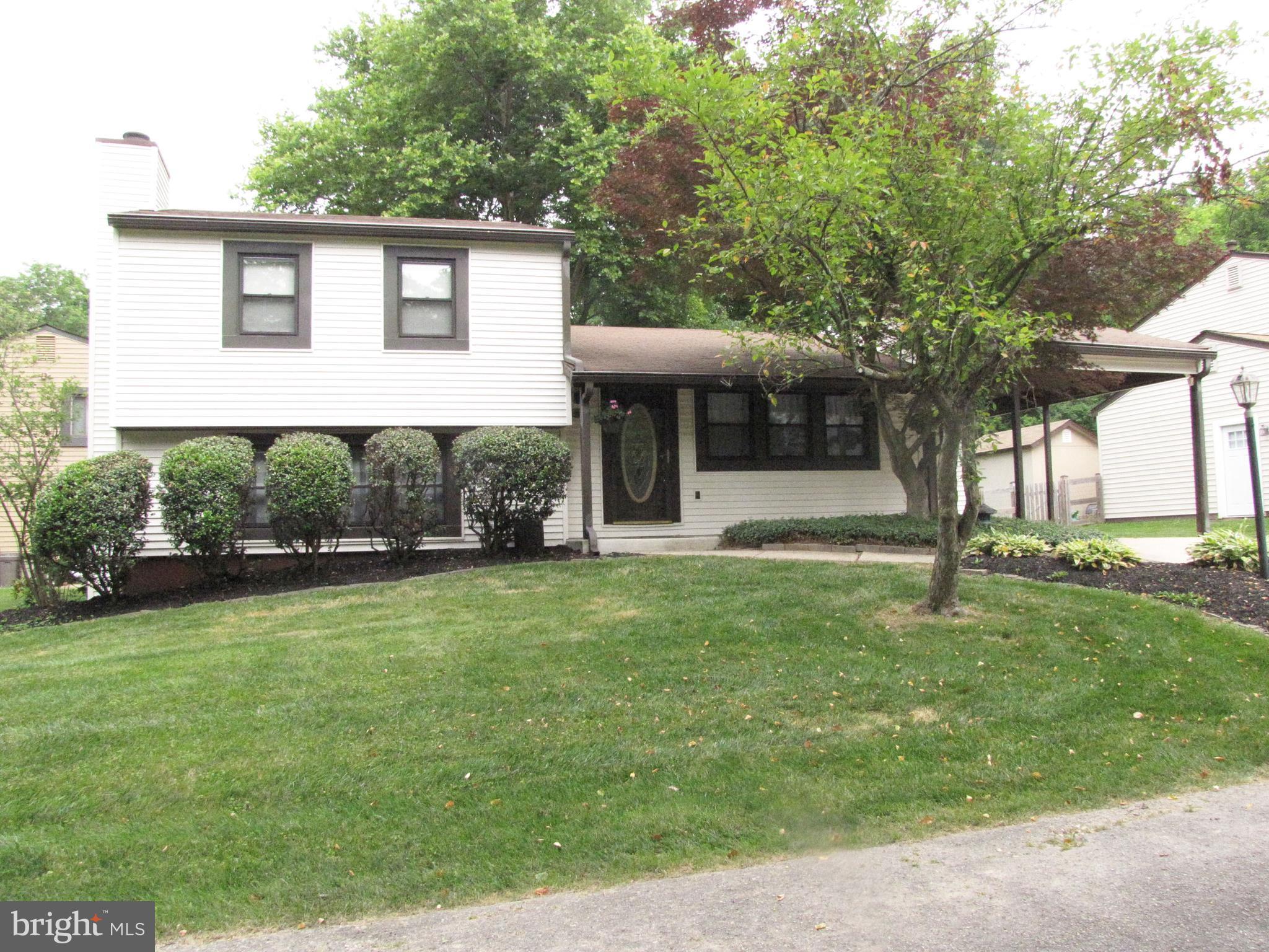 9600 Farewell Road Columbia, MD 21045 - Photo 2 of 18 a front view of a house with a yard and trees